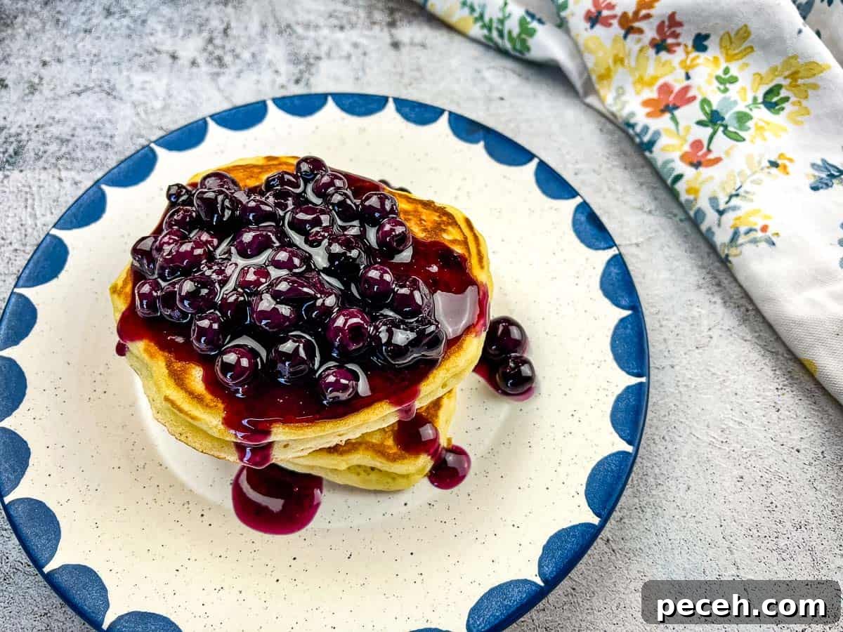 17 Mother’s Day Brunches You Can Enjoy Without Reservations or Parking Hassles 3 Buttermilk Pancakes with Blueberry Sauce on a plate.