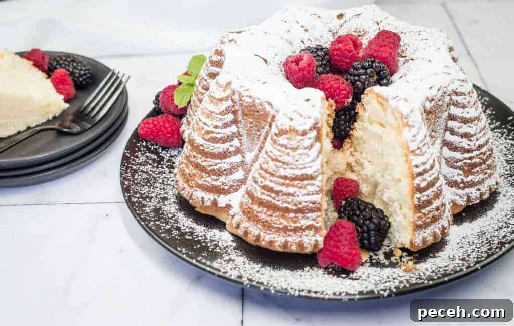 17 Mother’s Day Brunches You Can Enjoy Without Reservations or Parking Hassles 8 A powdered whipped cream cake garnished with raspberries and blackberries sits on a black plate.