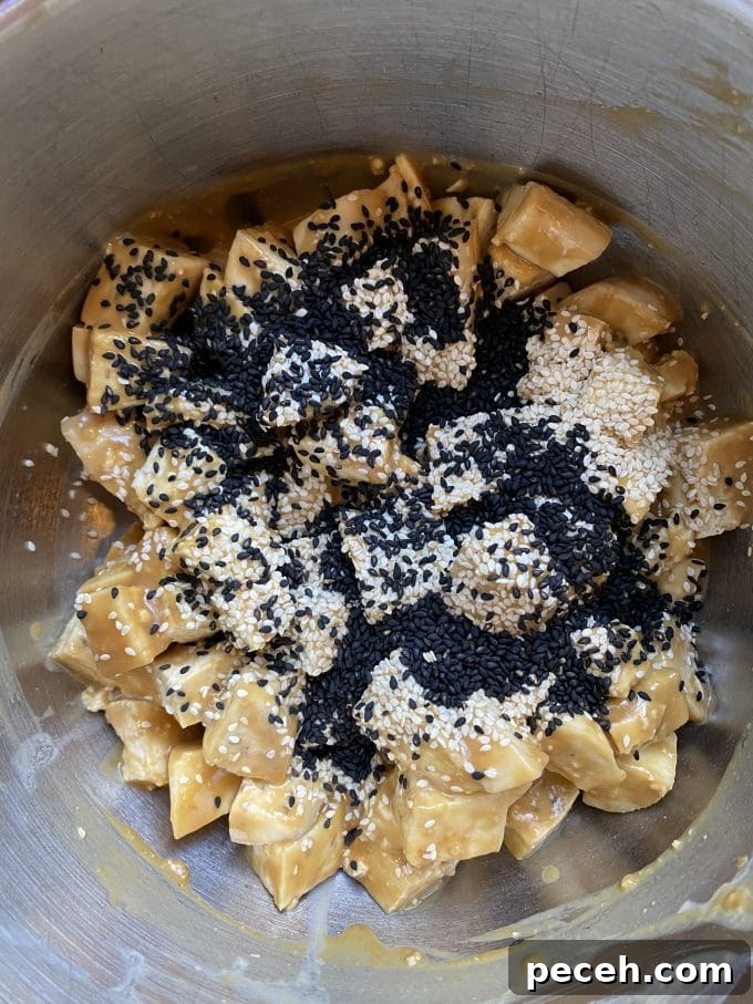 A bowl of tofu with sesame seeds and a tahini miso mixture