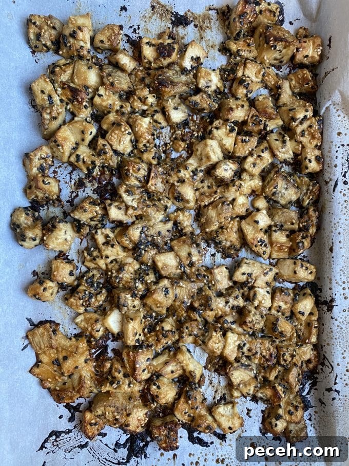 A baking sheet with baked eggplant and tofu with tahini-miso