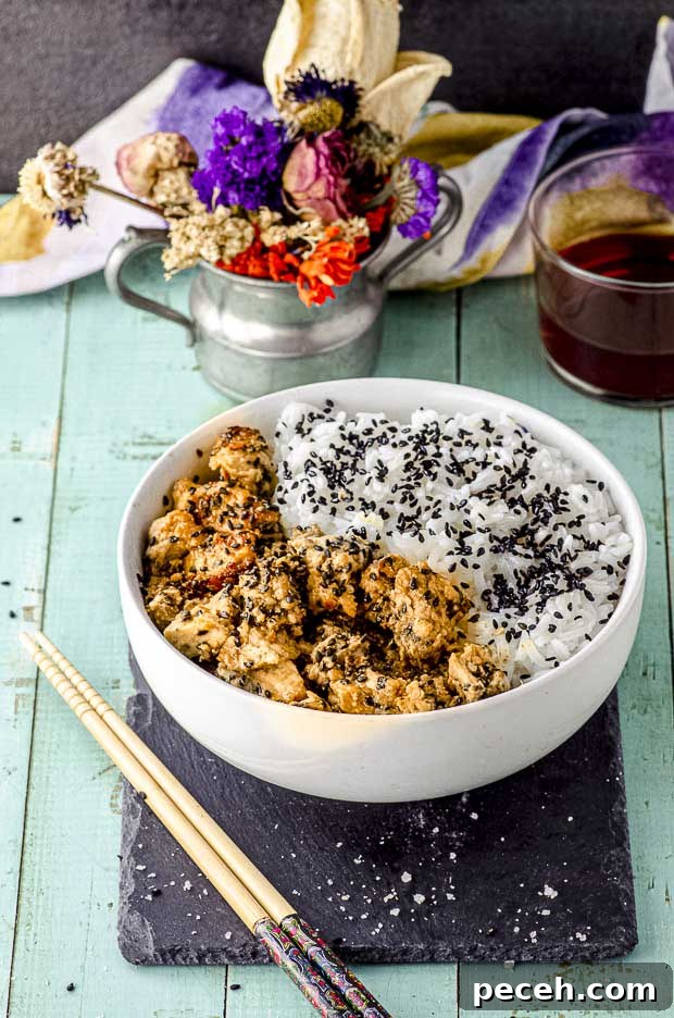 Side view of a white bowl with tahini-miso eggplant rice bowl