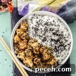 Bird's eye view of a bowl with rice and tahini miso eggplant