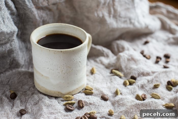 Romantic Date Night Dinner Recipes for Two 7 Small white mug of Cardamom Coffee, surrounded with cardamom pods