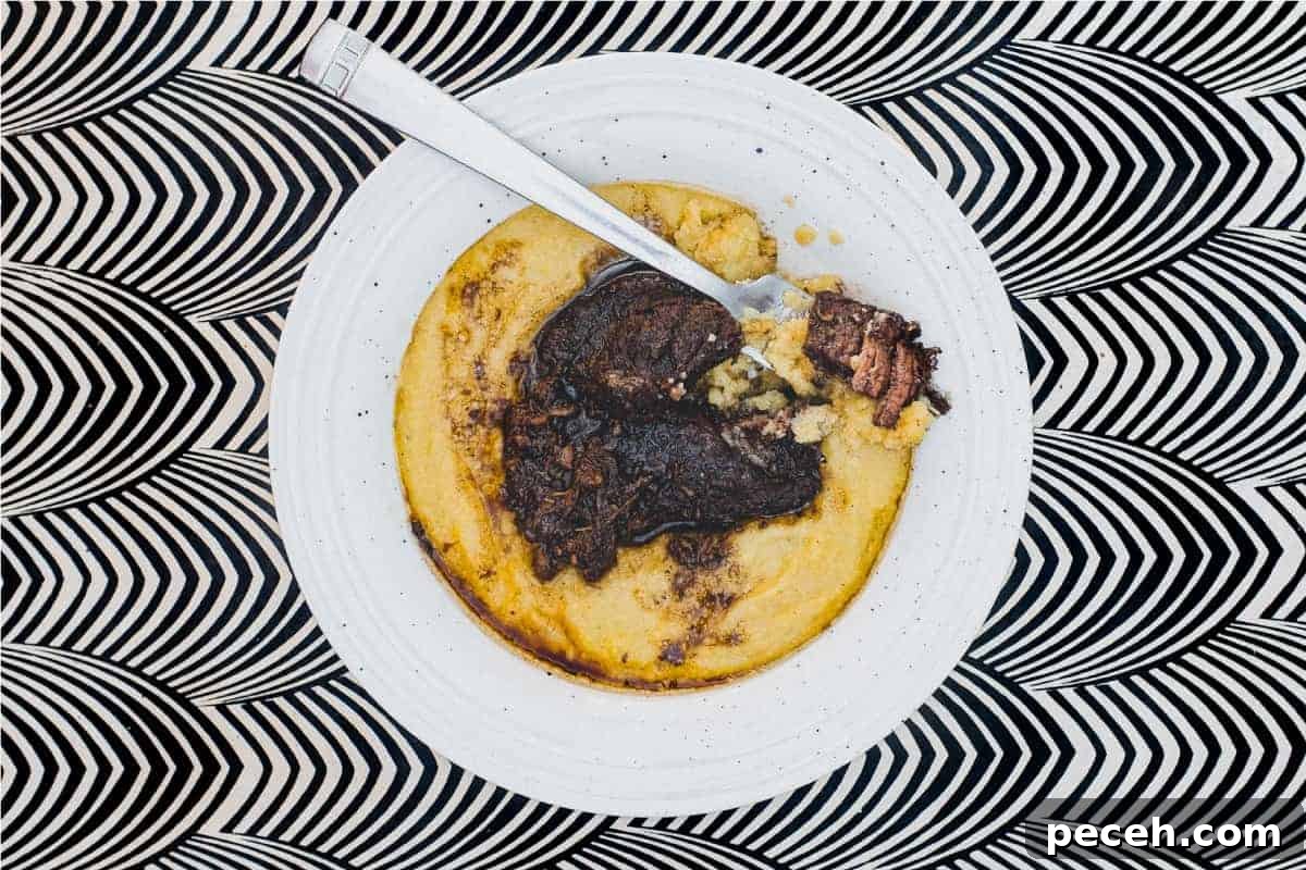 Peposo alla Fornacina: Traditional Tuscan Beef Stew Recipe 2 A bowl of Creamy Polenta with Peposo Alla Fornacina (Tuscan Beef Stew)