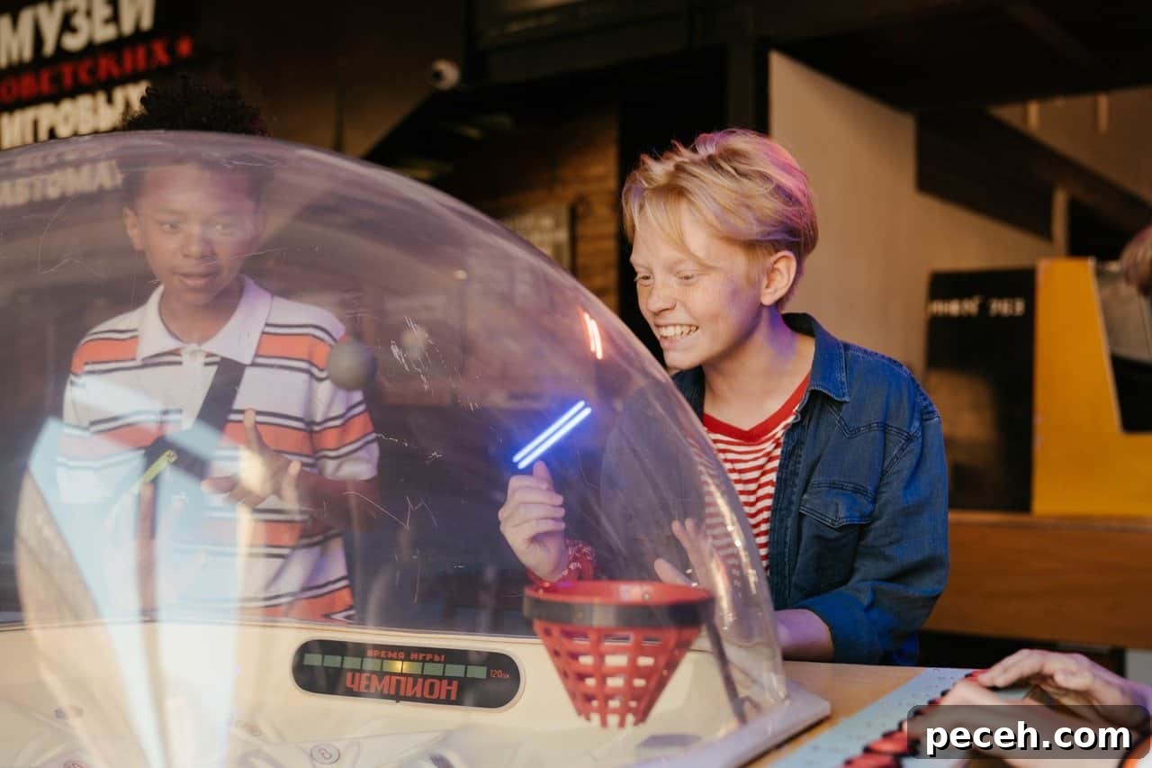 17 Fun and Memorable 13th Birthday Party Ideas 13 Two boys playing an arcade game.