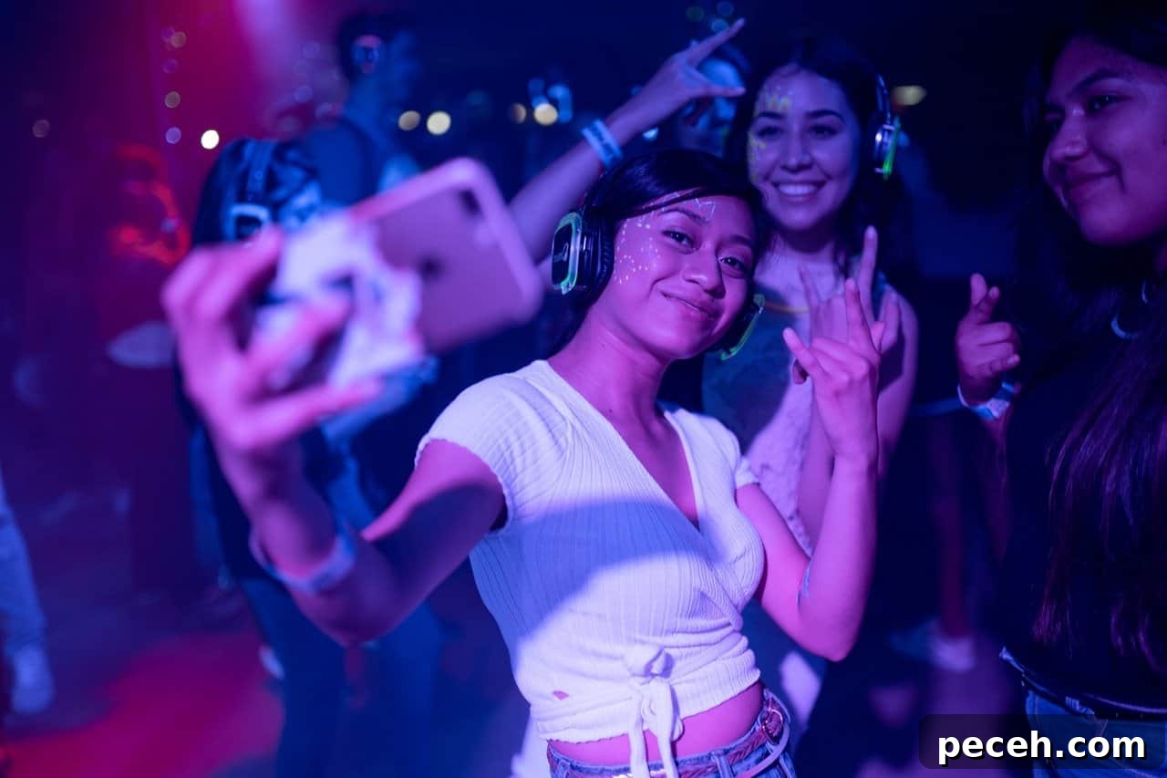 17 Fun and Memorable 13th Birthday Party Ideas 4 Woman taking a selfie at a dance party.