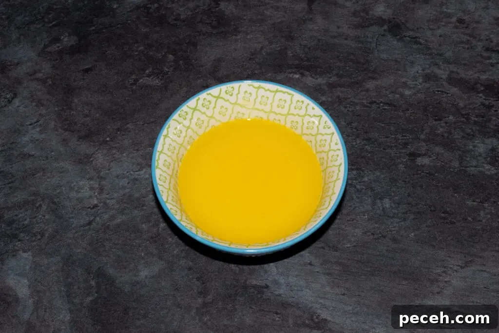 Crème Egg Cookie Recipe: Gooey Chocolate and Cadbury Filling 12 Melted butter in a small blue patterned bowl