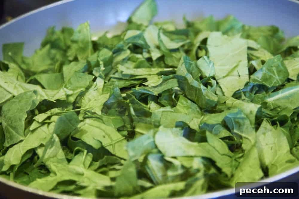 Kale and Walnut Pesto Recipe — Bright Sauce for Pasta & Toast 4 Fresh kale in a grey skillet.