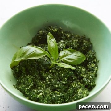 Kale and Walnut Pesto Recipe — Bright Sauce for Pasta & Toast 7 Kale pesto in a green bowl.