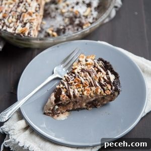 Decadent Mississippi Mud Ice Cream Pie Recipe 7 Slice of ice cream pie on a gray plate with a fork nearby