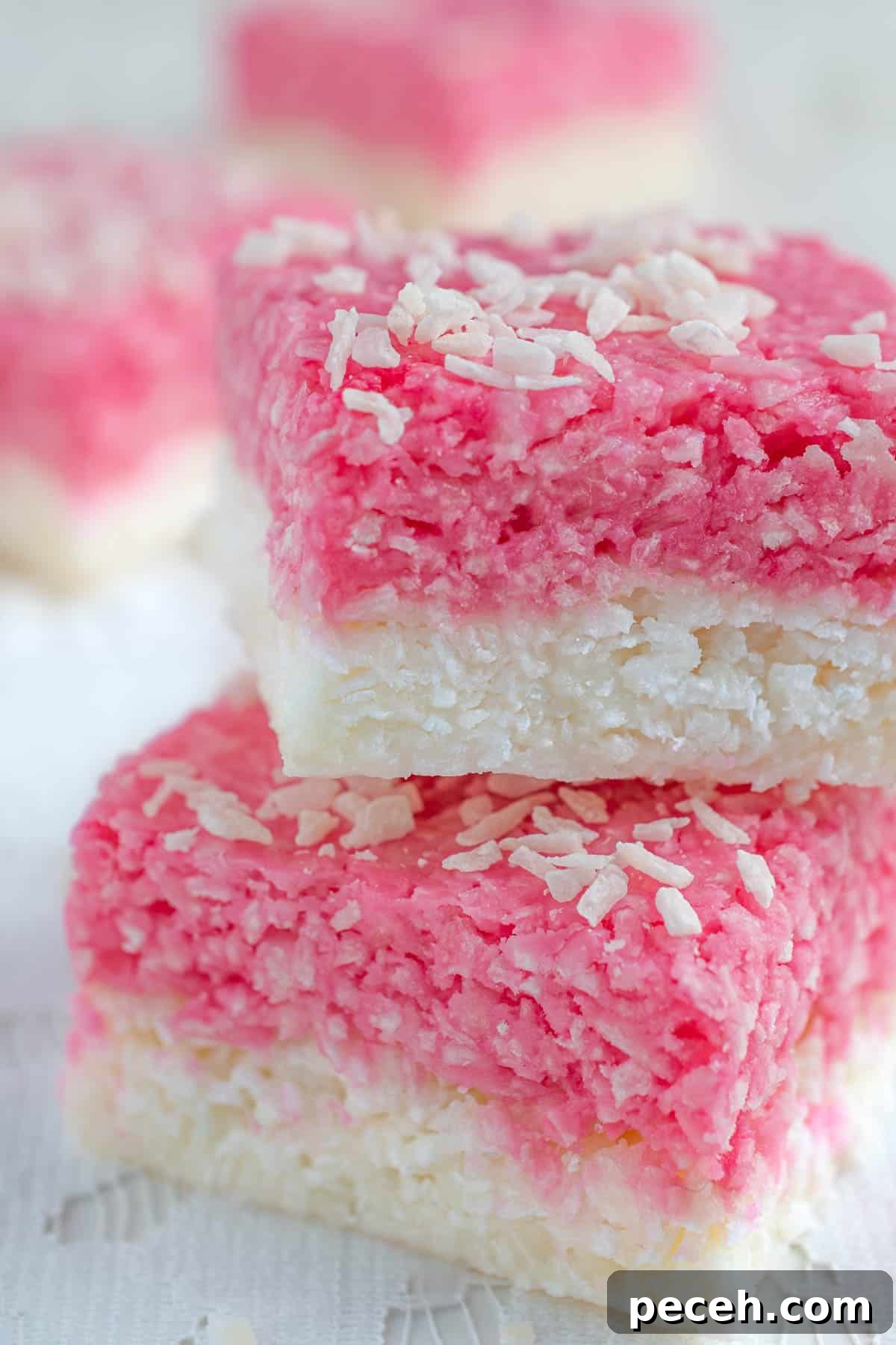 Coconut Ice Recipe: Creamy No-Bake Coconut Candy Tutorial 2 A few squares of coconut ice on a lace tablecloth.