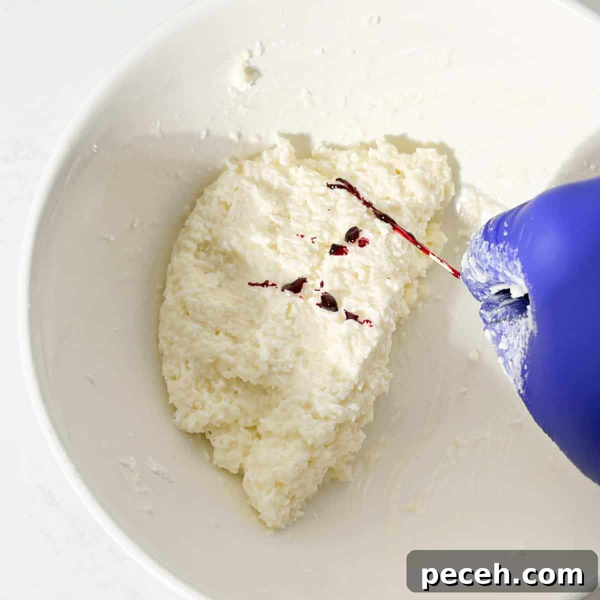 Coconut Ice Recipe: Creamy No-Bake Coconut Candy Tutorial 11 Adding food colouring to one half of the coconut ice mixture.