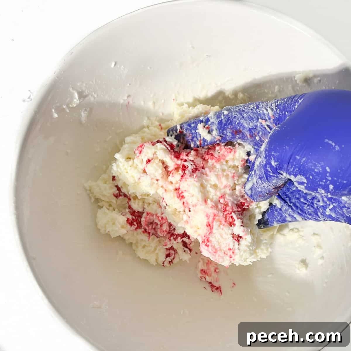 Coconut Ice Recipe: Creamy No-Bake Coconut Candy Tutorial 12 Mixing the pink food colouring into the second half of the coconut ice mixture.