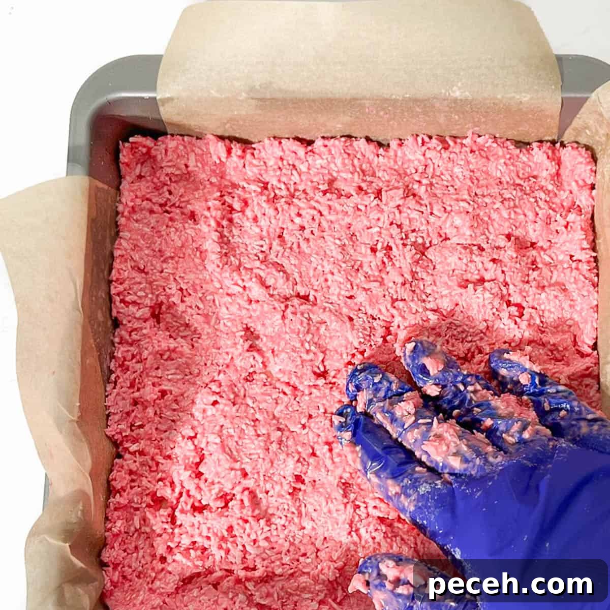 Coconut Ice Recipe: Creamy No-Bake Coconut Candy Tutorial 14 Spreading the pink mixture into the tin.