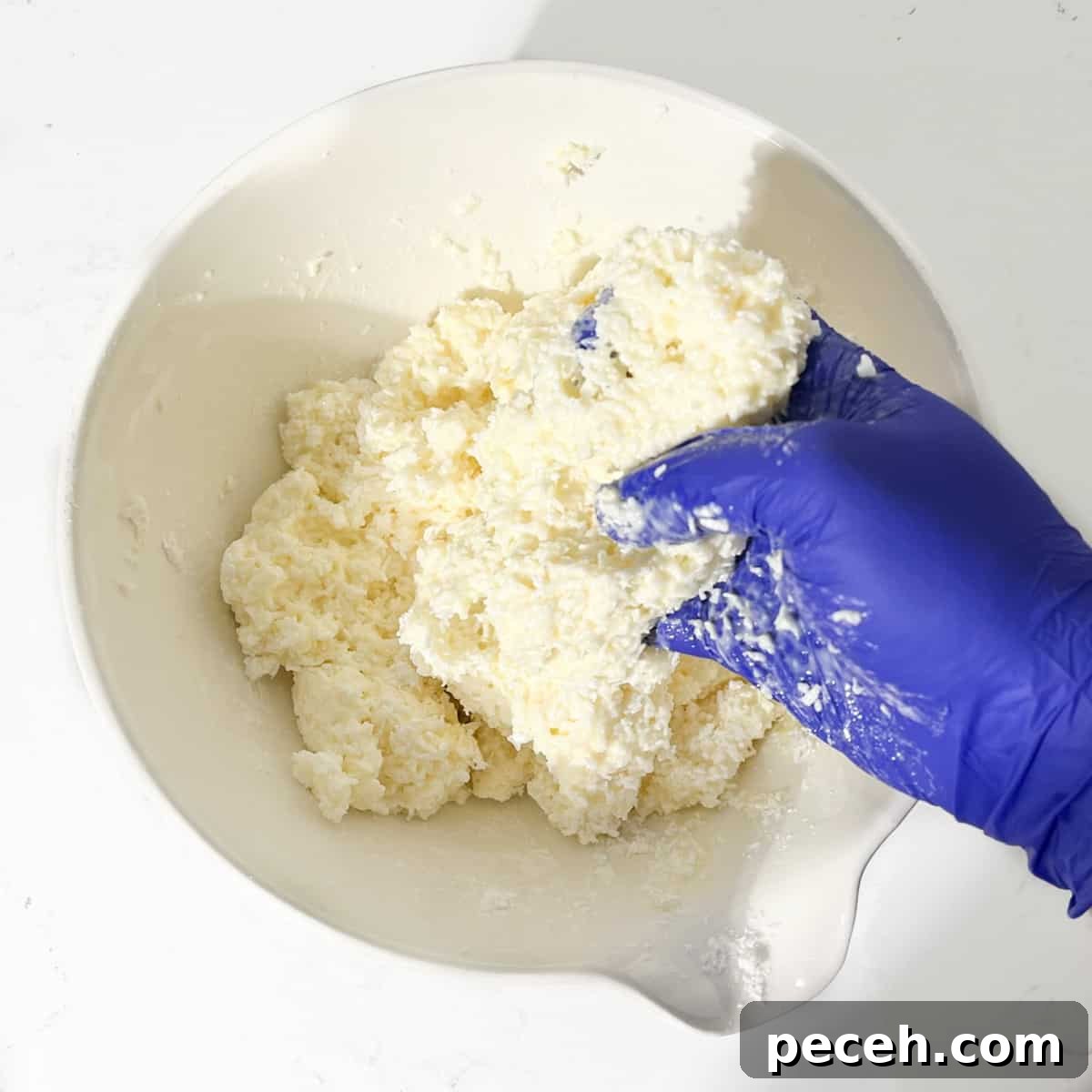 Coconut Ice Recipe: Creamy No-Bake Coconut Candy Tutorial 7 Mixing the coconut ice mixture by hand.