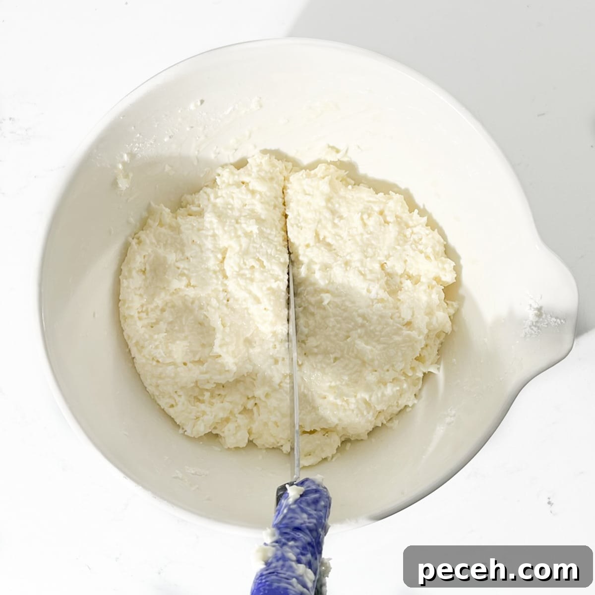 Coconut Ice Recipe: Creamy No-Bake Coconut Candy Tutorial 8 Dividing the coconut ice mixture in half.