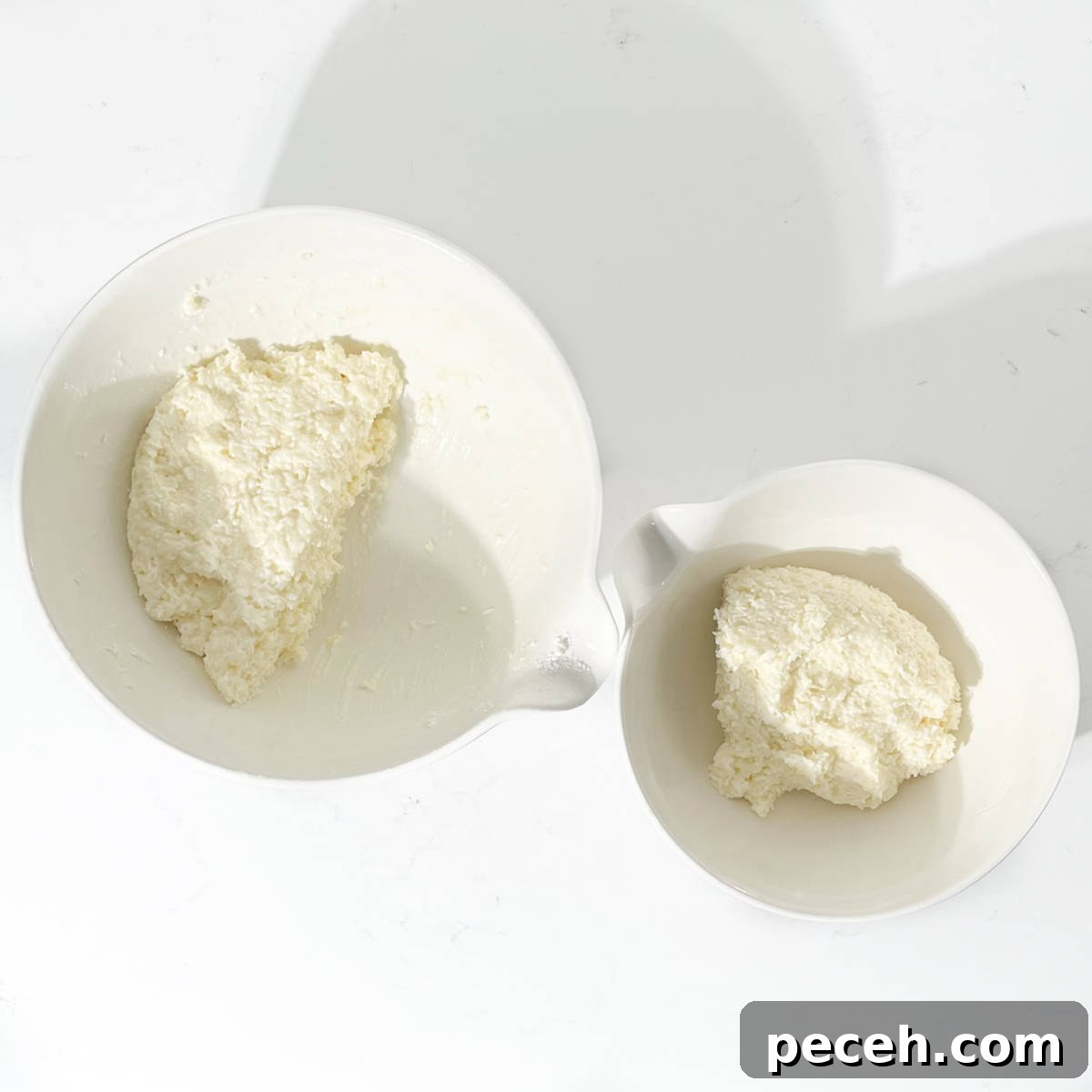 Coconut Ice Recipe: Creamy No-Bake Coconut Candy Tutorial 9 Two bowls with coconut ice mixture.