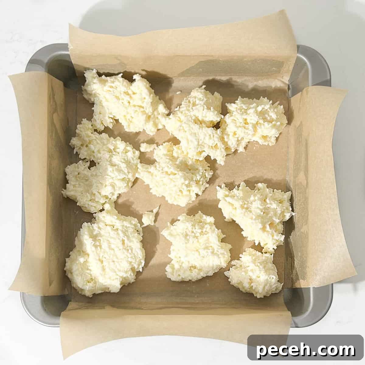 Coconut Ice Recipe: Creamy No-Bake Coconut Candy Tutorial 10 Dicing the white half of the coconut mixture into the tin.