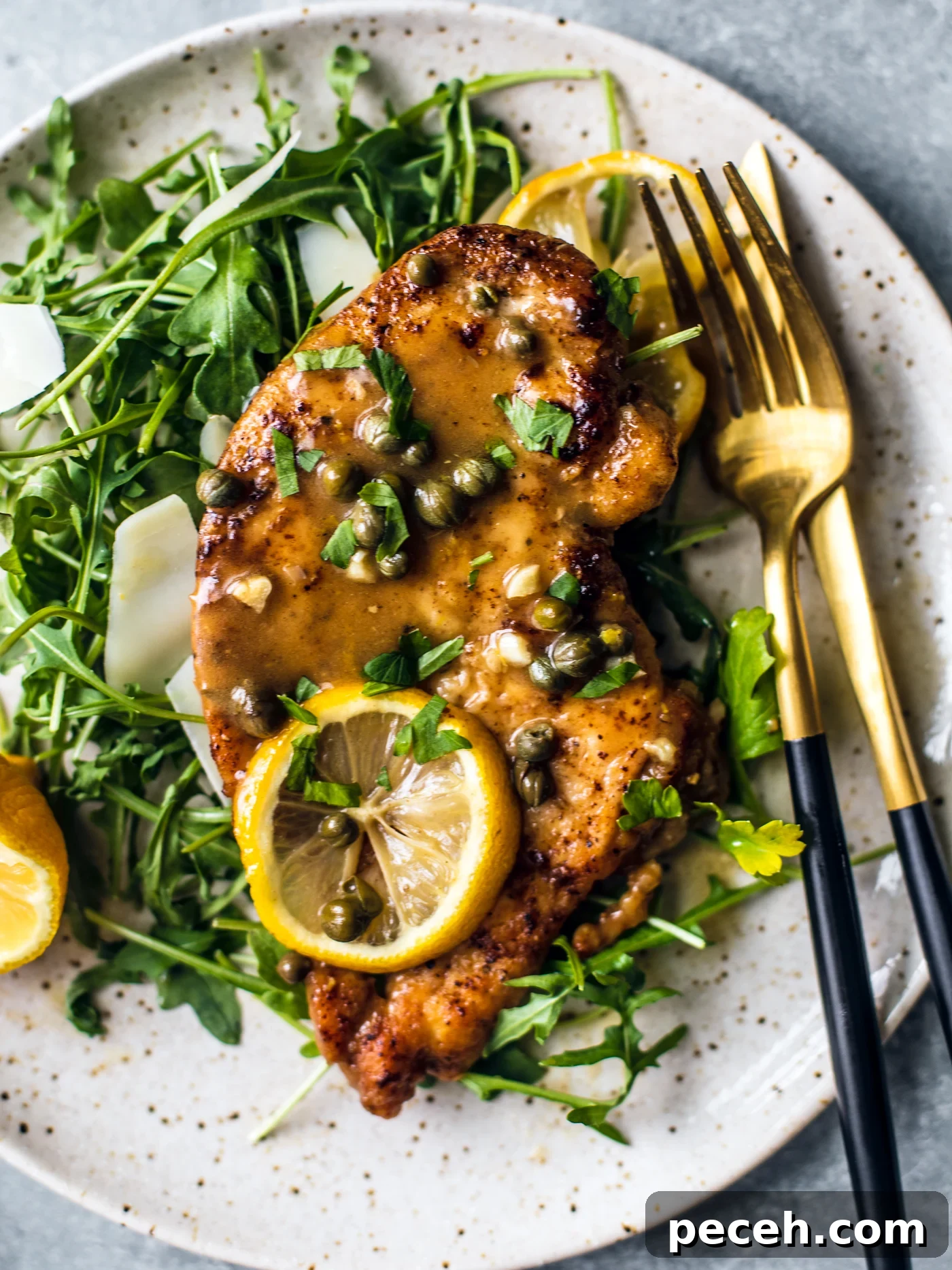 Classic Chicken Piccata Recipe with Lemon & Capers 9 Saucy chicken piccata served over arugula.