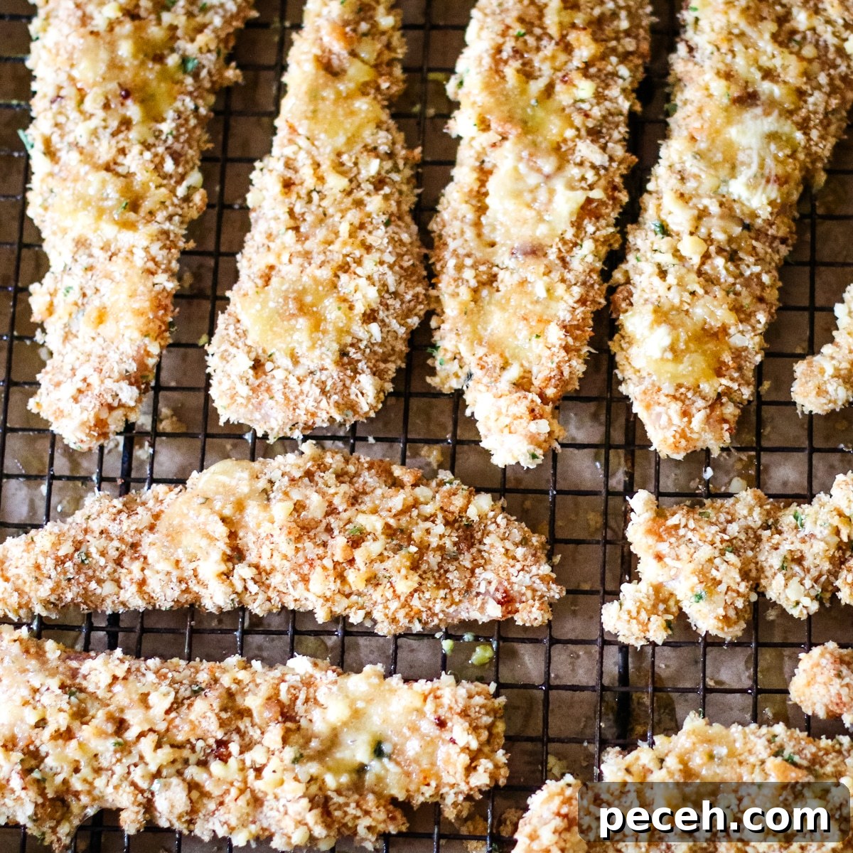 chicken cutlets on a rack ready for the oven.