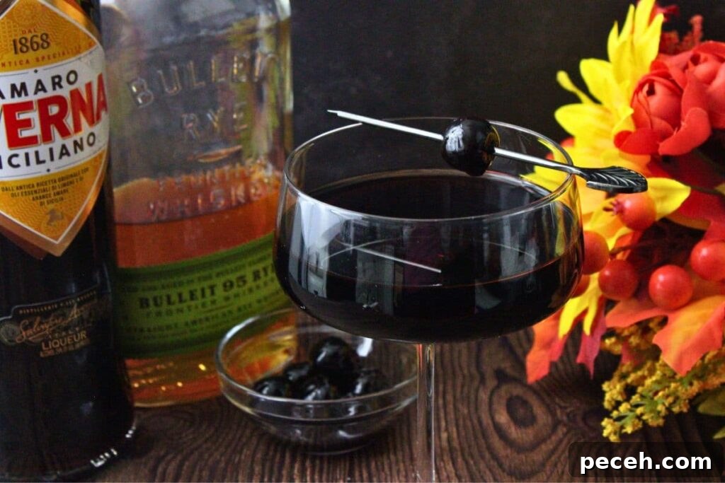 Black Manhattan Cocktail: A Bold, Smoky Twist on the Classic 3 black manhattan cocktail up close with liquor bottles and flowers behind