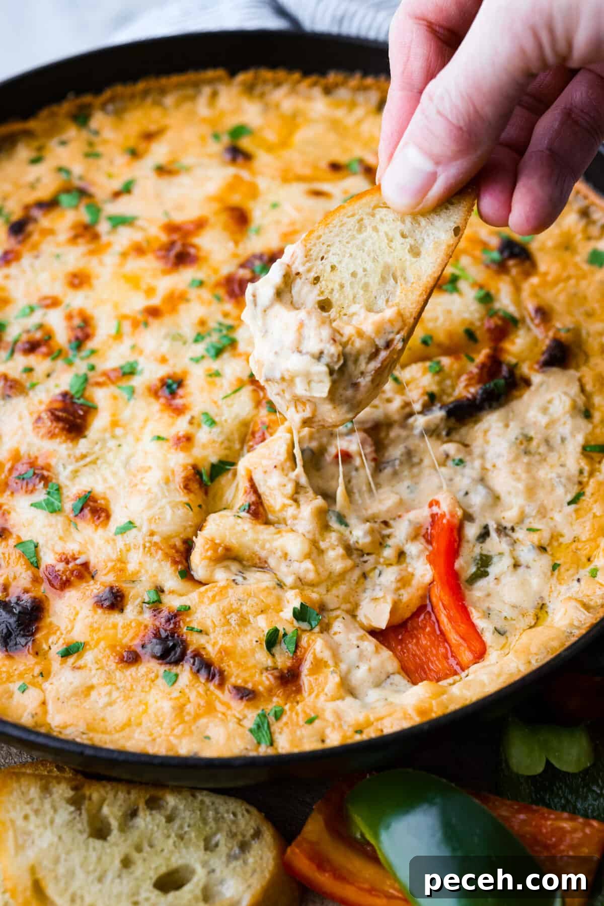 Dipping into the Philly cheesesteak dip with crostini.