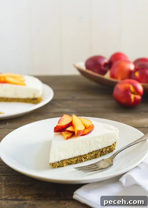 No-Bake Goat Cheese Cheesecake with Nectarine Compote 2 A slice of No-Bake Goat Cheese Cheesecake with Nectarine Compote on a white plate.