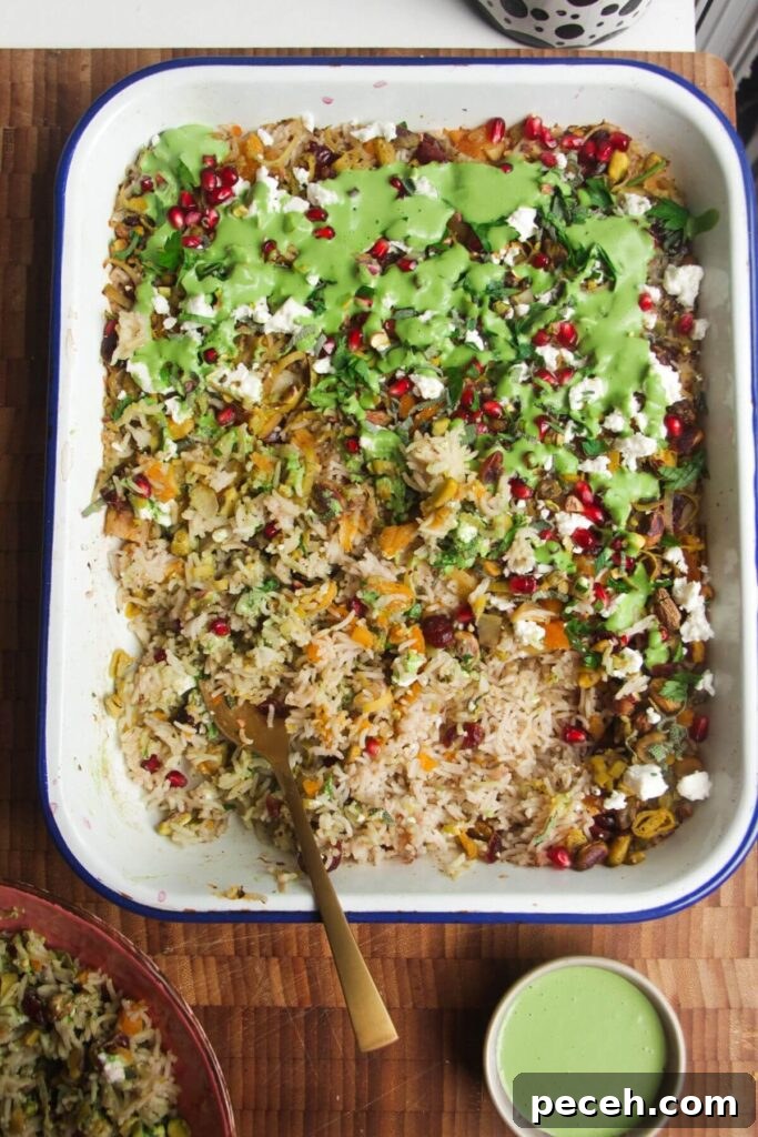 Cranberry-Dressed Crispy Rice Salad for Holiday Gatherings 11 Spoon in baked rice topped with feta, pomegranate seeds and green tahini sauce.