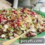 Festive crispy rice salad on a large green platter.