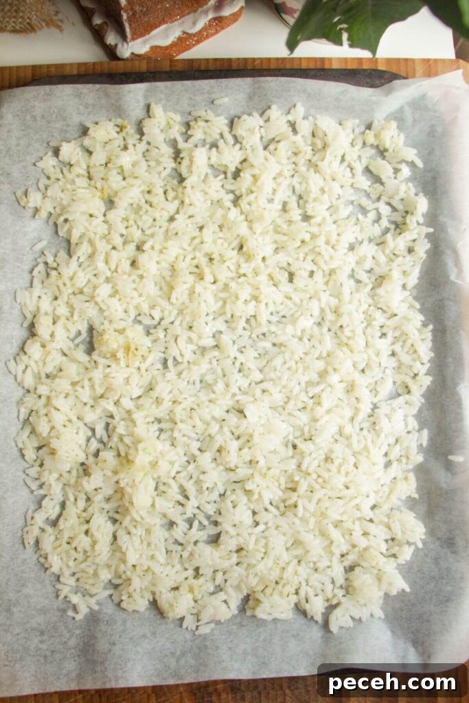 Cranberry-Dressed Crispy Rice Salad for Holiday Gatherings 5 Rice spread out on a lined oven tray.
