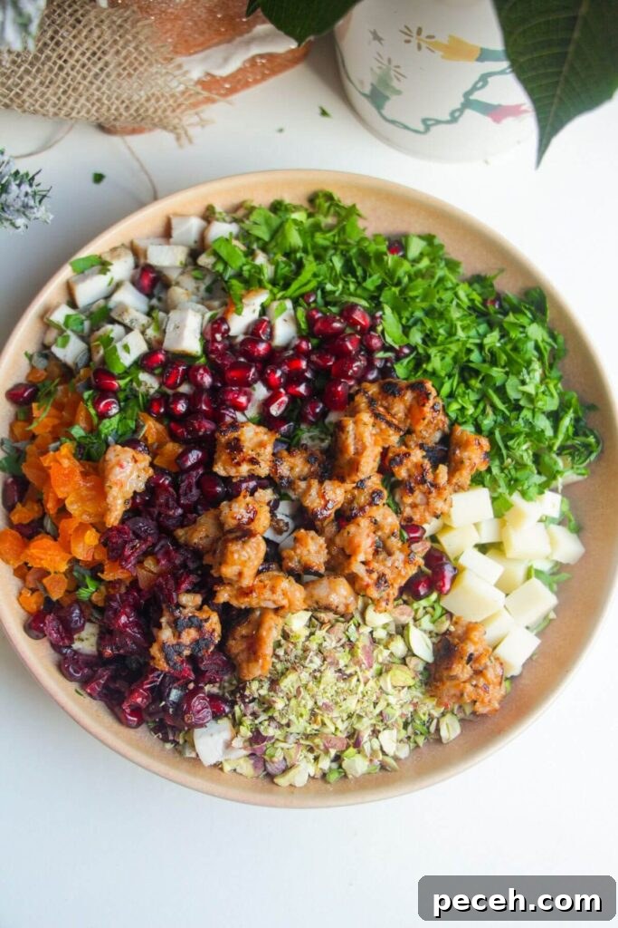 Cranberry-Dressed Crispy Rice Salad for Holiday Gatherings 6 Ingredients for crispy rice salad in a pink bowl.