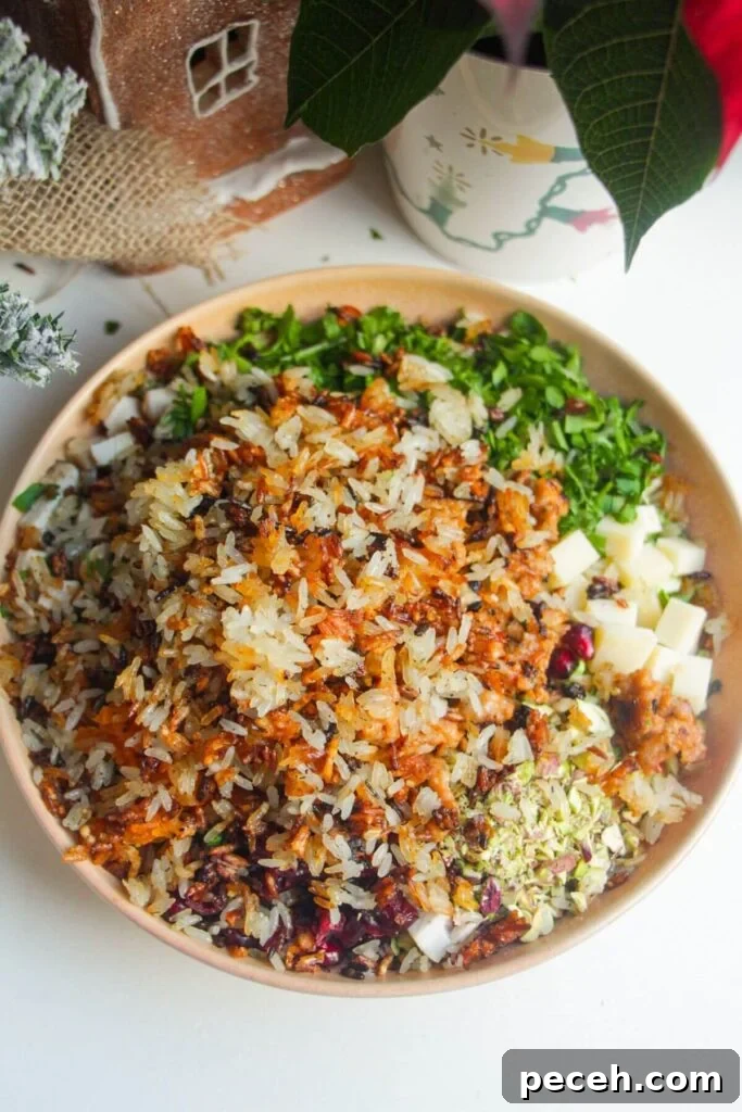 Cranberry-Dressed Crispy Rice Salad for Holiday Gatherings 7 Crispy rice added to bowl with other salad ingredients.