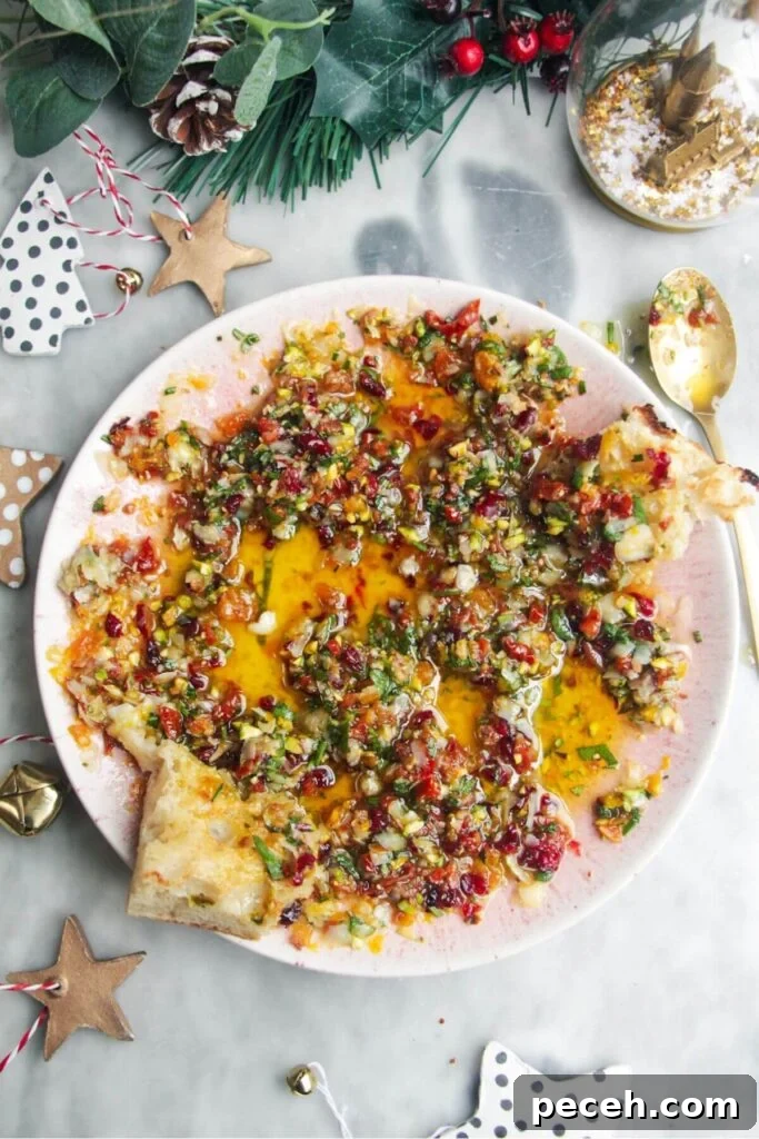 Cranberry-Dressed Crispy Rice Salad for Holiday Gatherings 10 Colourful dipping oil in a small pink plate on a grey background.
