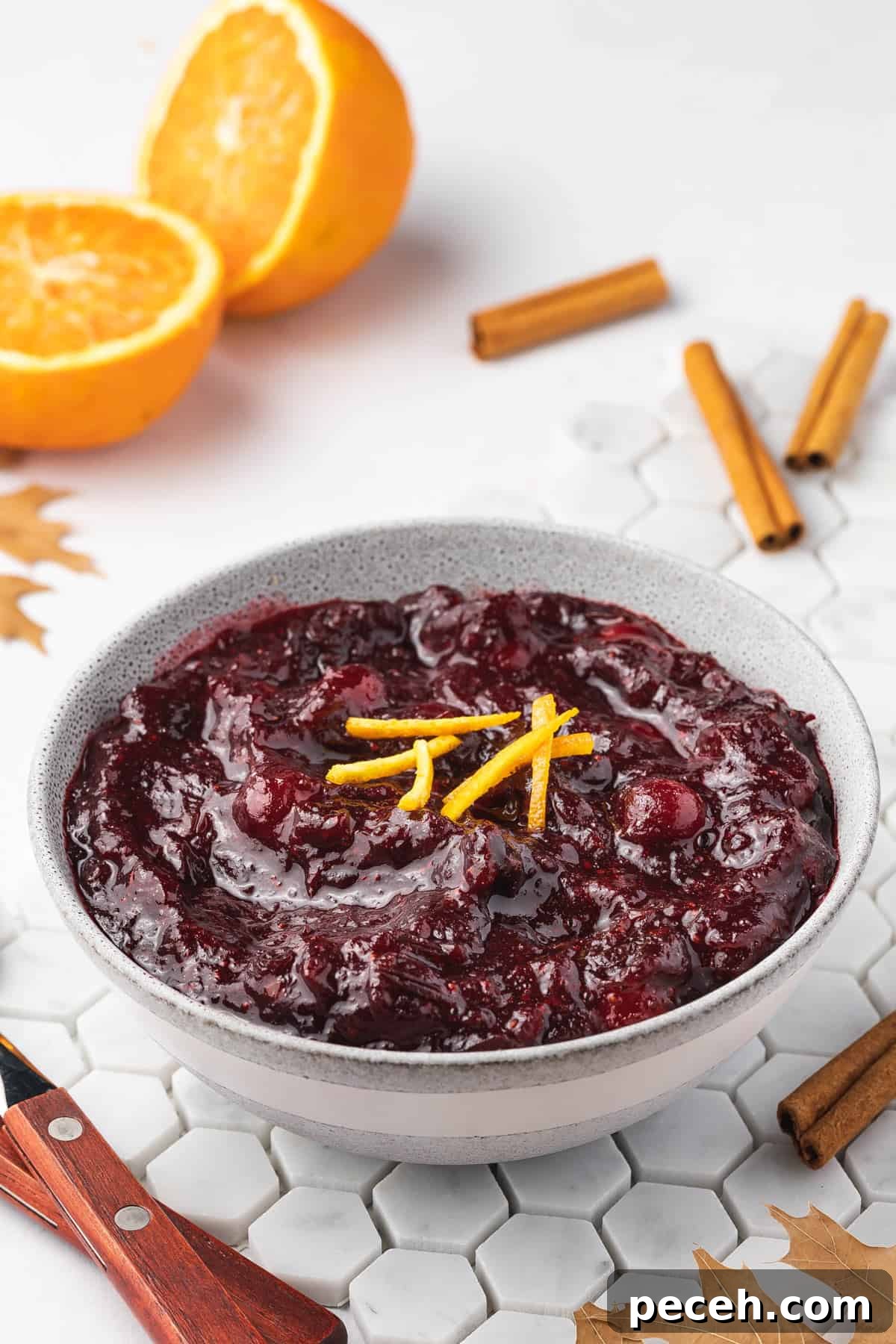 Slow Cooker Cranberry Sauce Recipe for Thanksgiving 10 An angled view of a bowl of crockpot cranberry sauce.