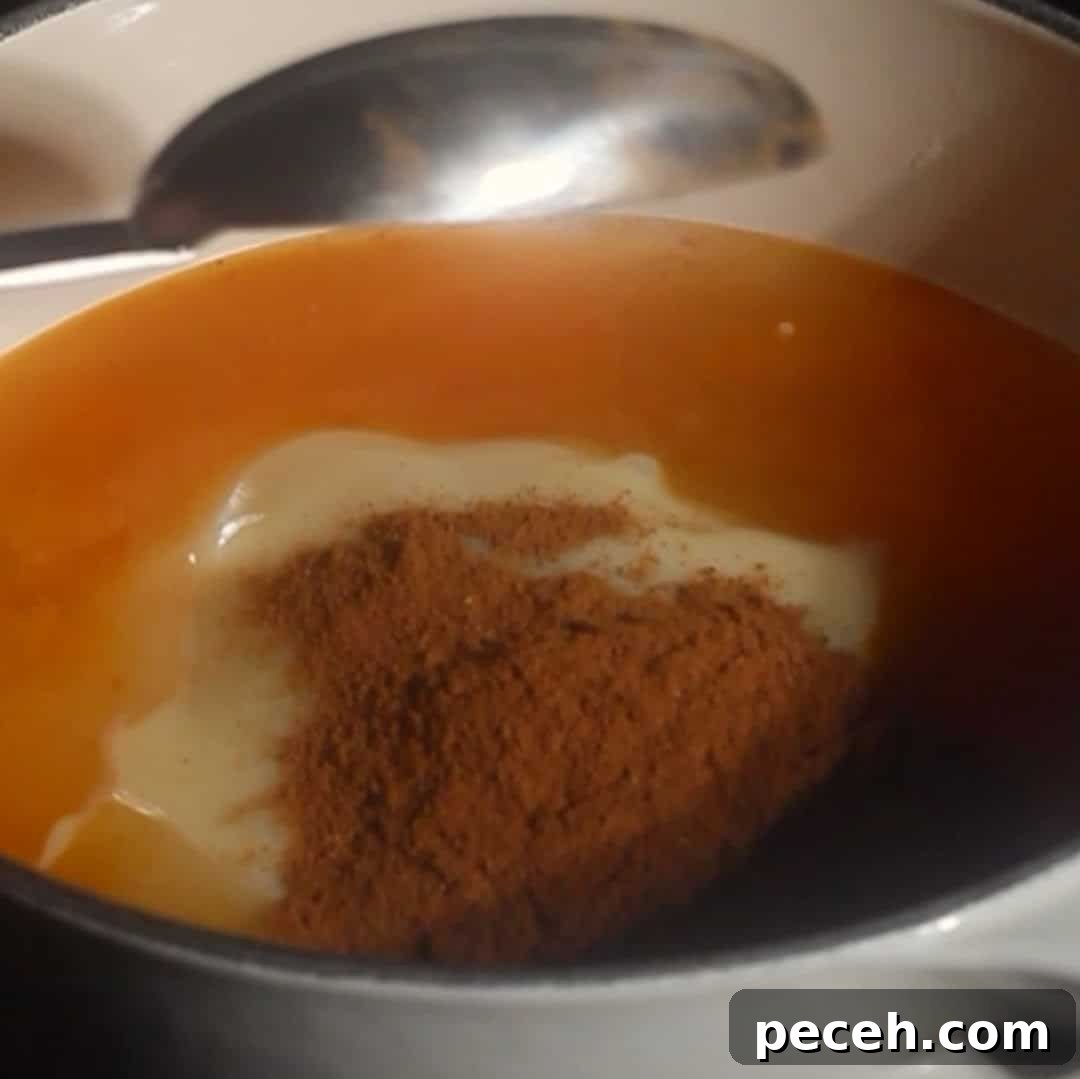 Pumpkin puree, condensed milk, and pumpkin spice added to saucepan to make pumpkin cold foam base.