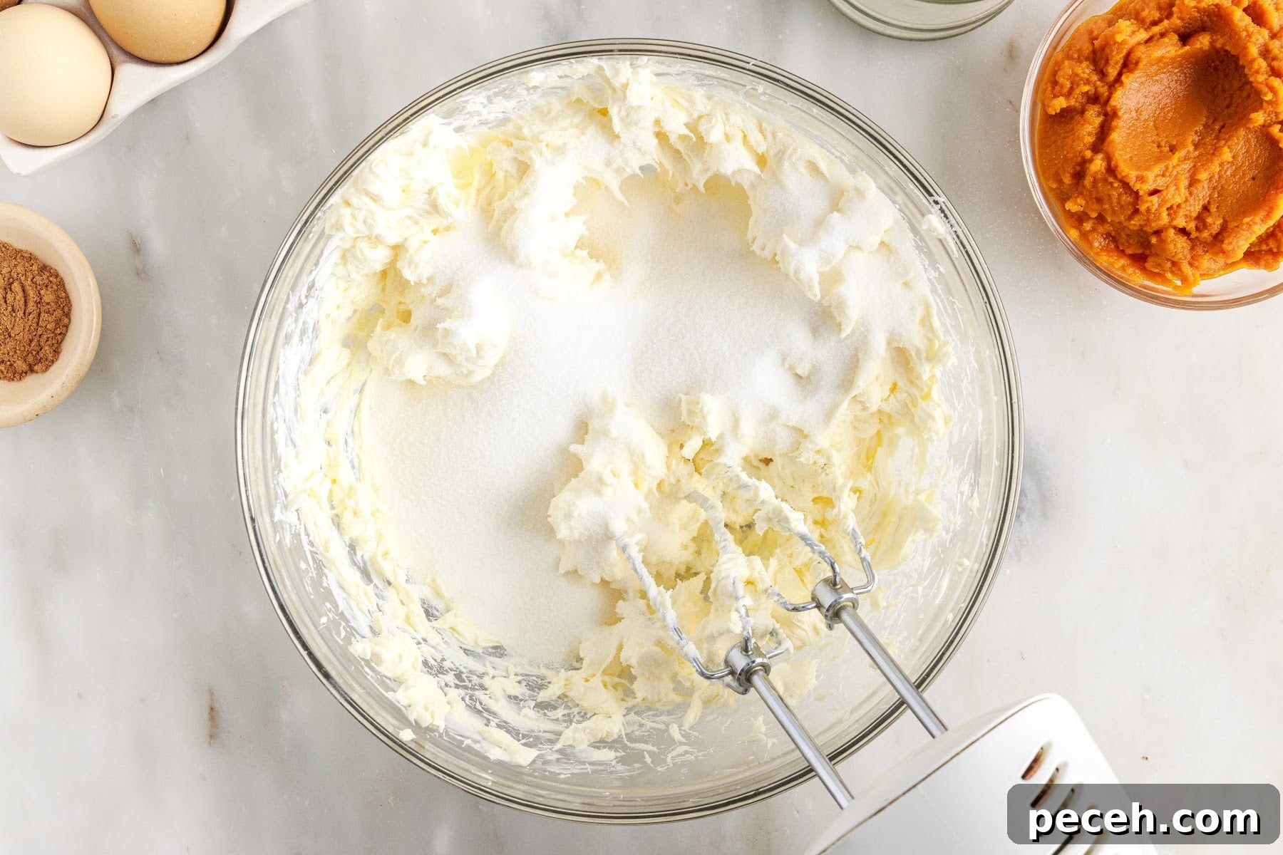 Beaten cream cheese and sugar in a mixing bowl.