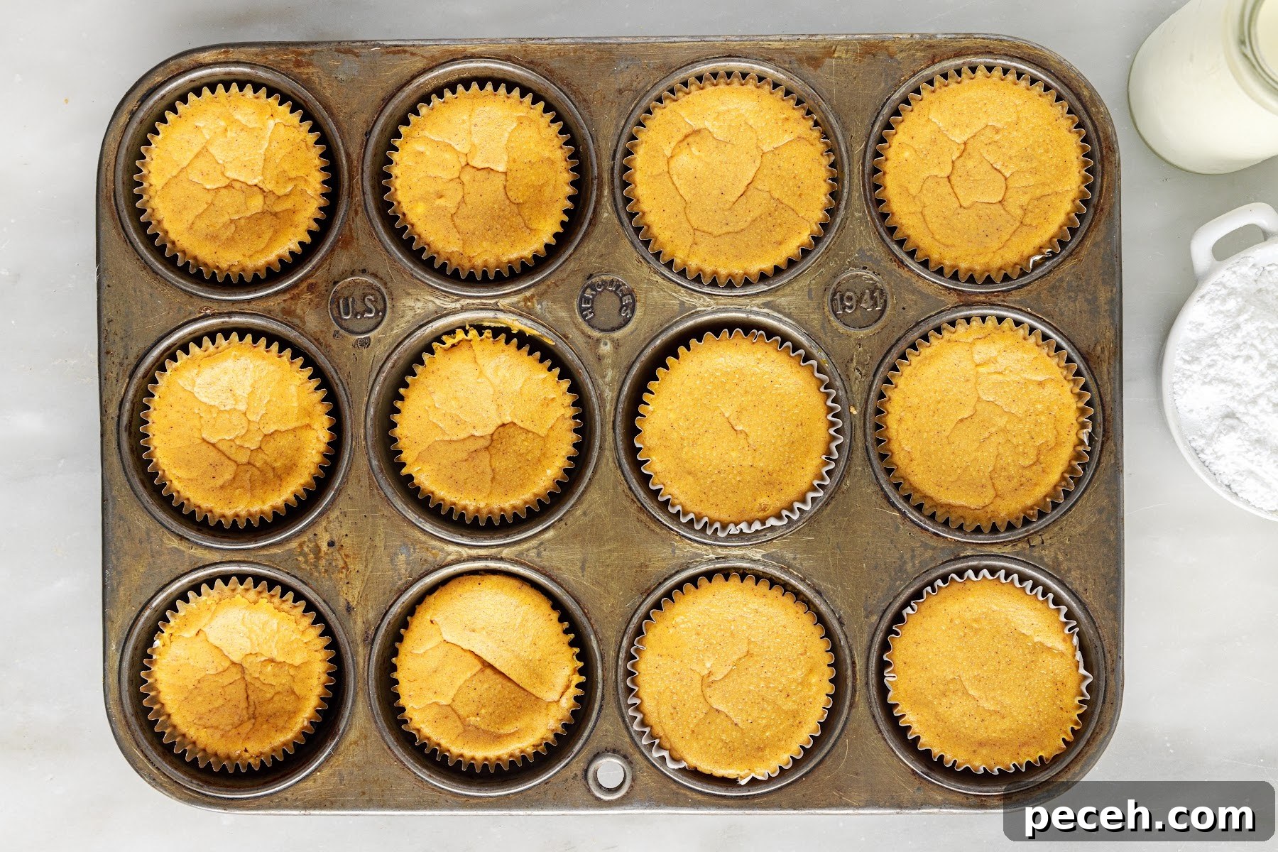 Baked mini pumpkin cheesecakes in muffin tin.
