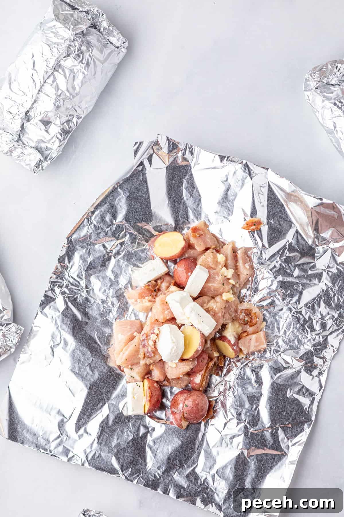Cheesy Crack Chicken Foil Packet Dinner Recipe 5 Adding Crack Chicken Foil Packets ingredients to tin foil