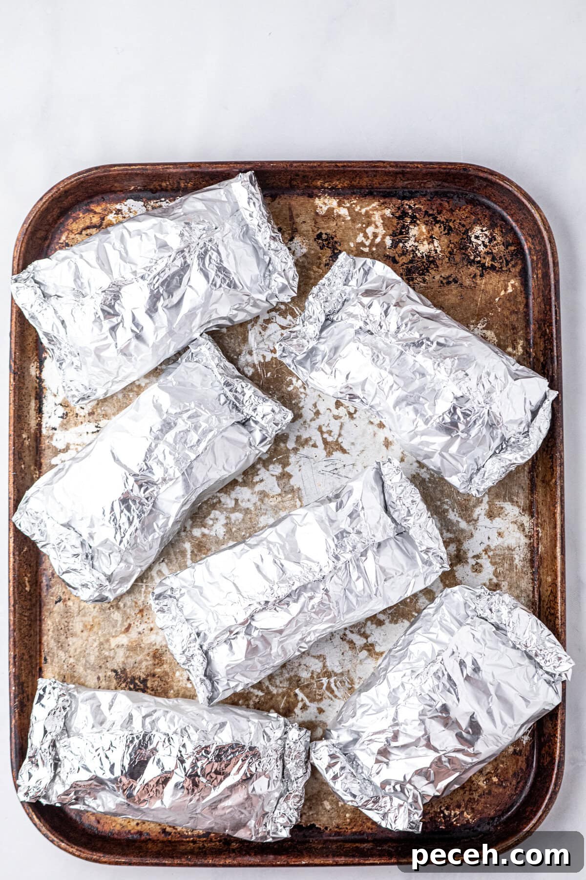 Cheesy Crack Chicken Foil Packet Dinner Recipe 6 Wrapping Crack Chicken Foil Packets and arranging them on cooking sheet
