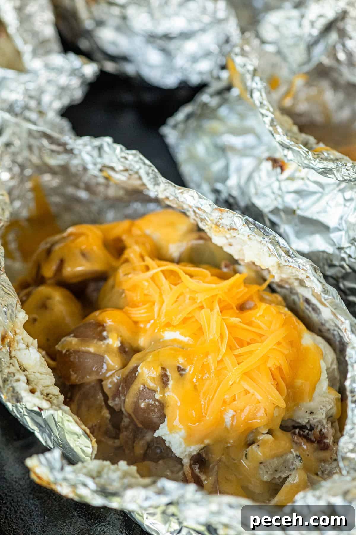 Cheesy Crack Chicken Foil Packet Dinner Recipe 9 Adding shredded cheese to Crack Chicken Foil Packet