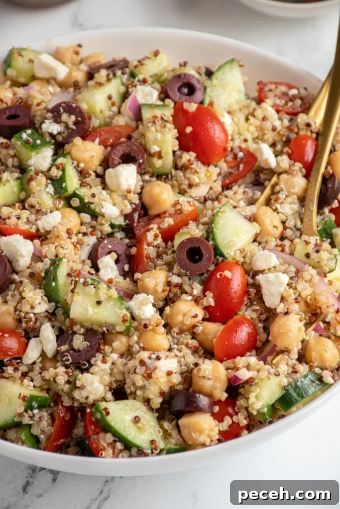 Greek Quinoa and Chickpea Salad with Feta and Olives 7 Close up of greek quinoa chickpea salad in a white bowl.