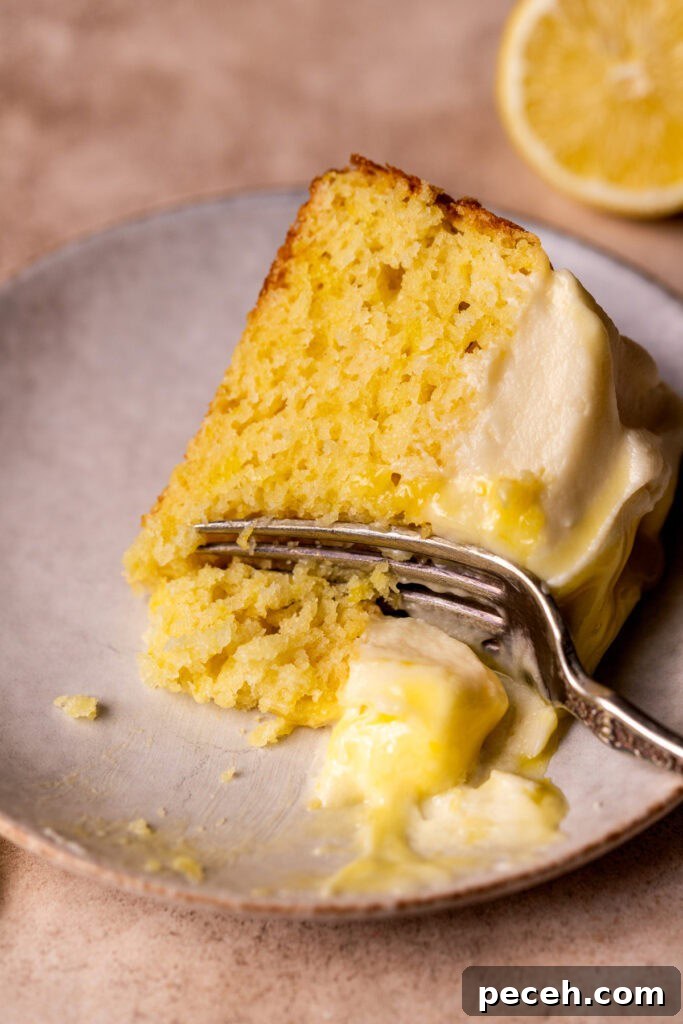 One slice of lemon curd cake on its side.