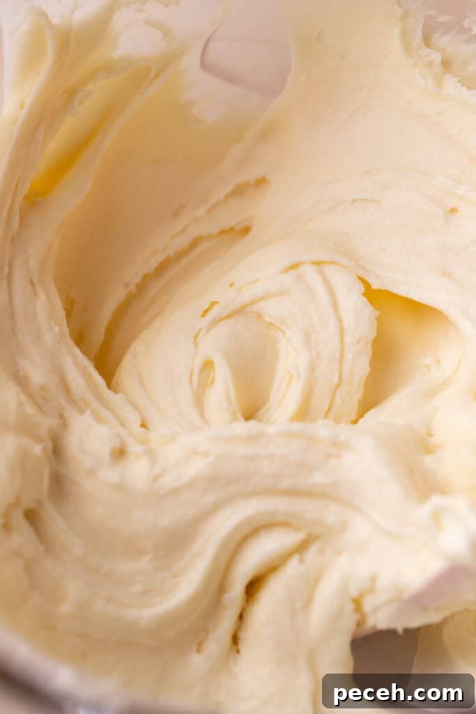Cream cheese frosting in a glass bowl.