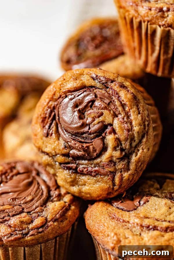 Chewy Banana Chocolate Chip Cookies Recipe for Perfect Bakes 11 banana nutella muffins stacked on top of each other