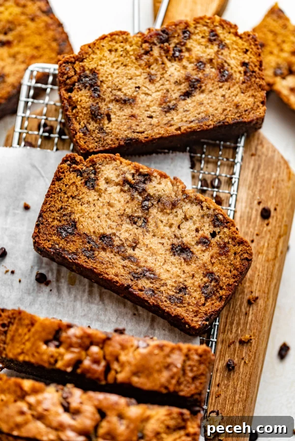 Chewy Banana Chocolate Chip Cookies Recipe for Perfect Bakes 13 one bowl chocolate chip banana bread sliced on a serving board.