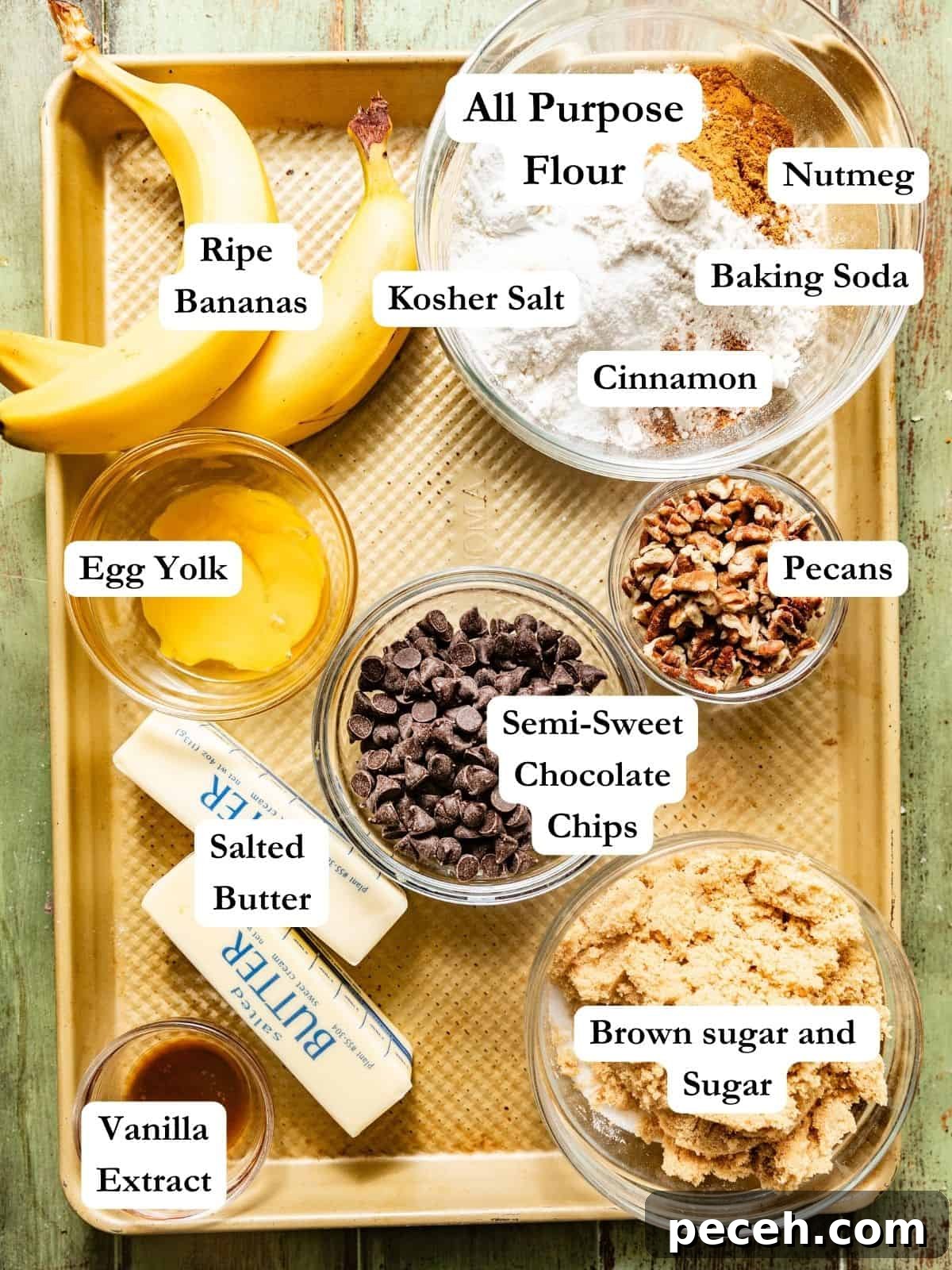 Chewy Banana Chocolate Chip Cookies Recipe for Perfect Bakes 3 ingredients to make banana chocolate chip cookies on a baking sheet - bananas, flour, cornstarch, baking soda, spices, brown sugar, sugar, vanilla extract, butter, chocolate chips, and pecans.