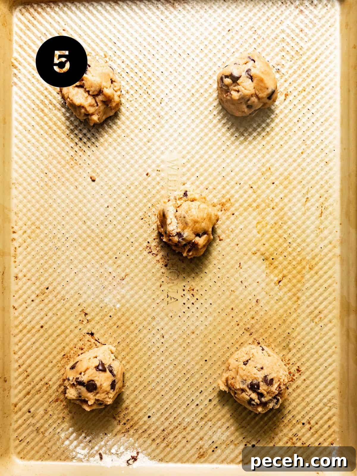 Chewy Banana Chocolate Chip Cookies Recipe for Perfect Bakes 8 cookie dough balls on a baking sheet.