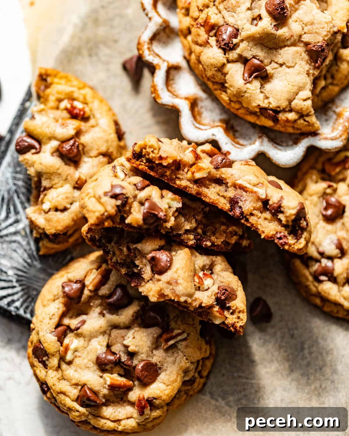Chewy Banana Chocolate Chip Cookies Recipe for Perfect Bakes 10 banana chocolate chip cookies cut in half on a piece of parchment paper.