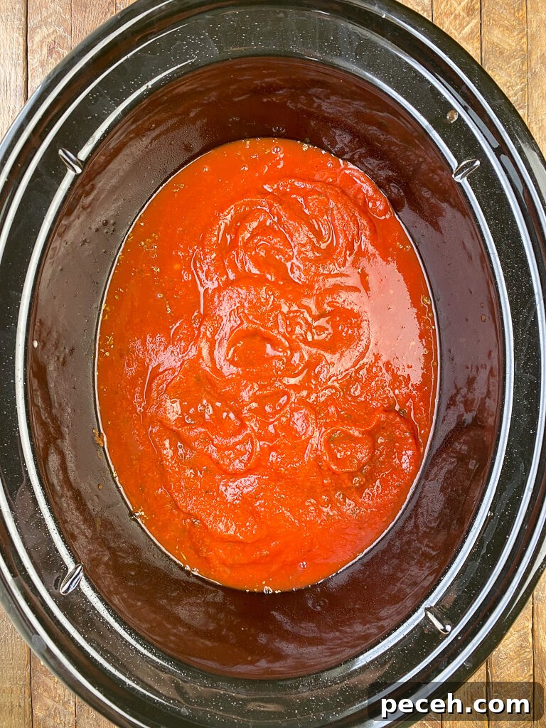 One-Pot Slow Cooker Chicken Parmesan Recipe 6 Pasta sauce covering up raw chicken breasts in crock pot