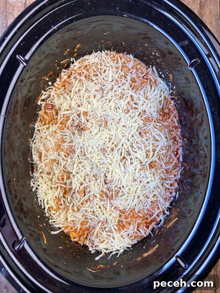 One-Pot Slow Cooker Chicken Parmesan Recipe 9 Shredded mozzarella cheese sprinkled on chicken parmesan cooked in the crock pot